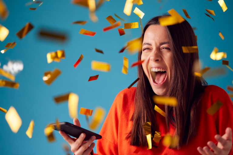 gold confetti falling over an excited woman who has won a prize